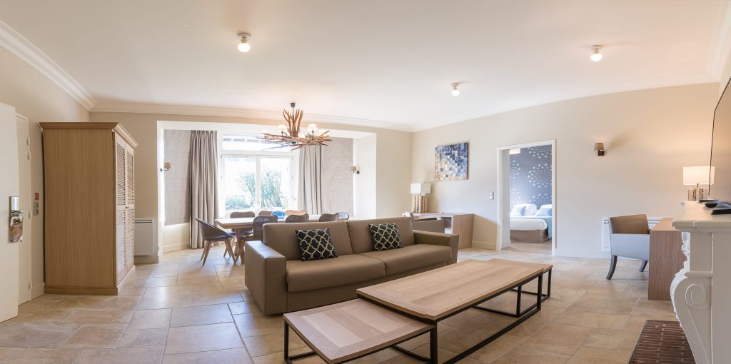 large living room with sofa and dining room in the prestige suite of the villa odette deauville